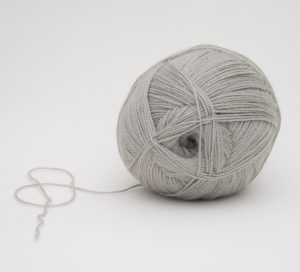 An unravelling ball of yarn, a metaphor for the Freelance Writer For Hire in Canada headline.